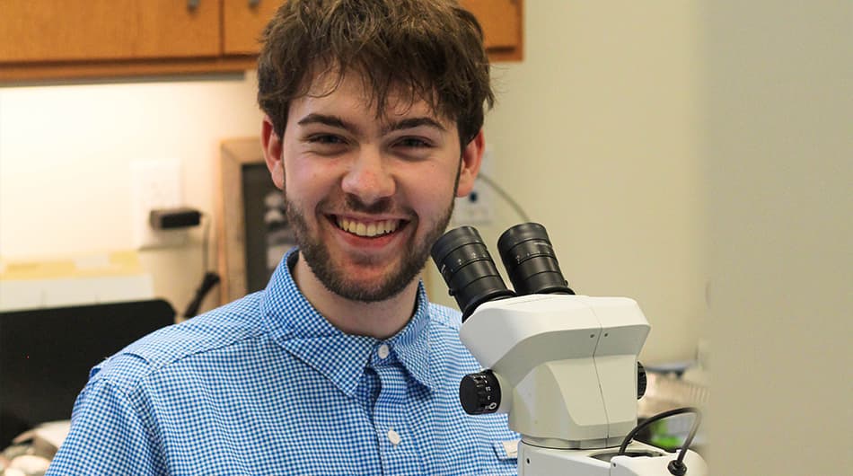 Nathan Jones, a freshman at Salisbury University, enthusiastically studies microbial biofilms during his internship. Photo credit: Reba Turner-Smith.