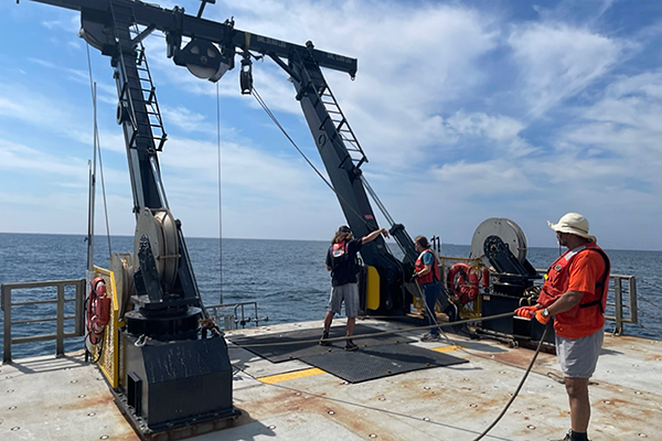 Deploying sea surface microlayer sampler in the Northwest Atlantic Ocean,  onboard the R/V Hugh Sharp. Photo Credit: Zackary Shepard (East Carolina University).