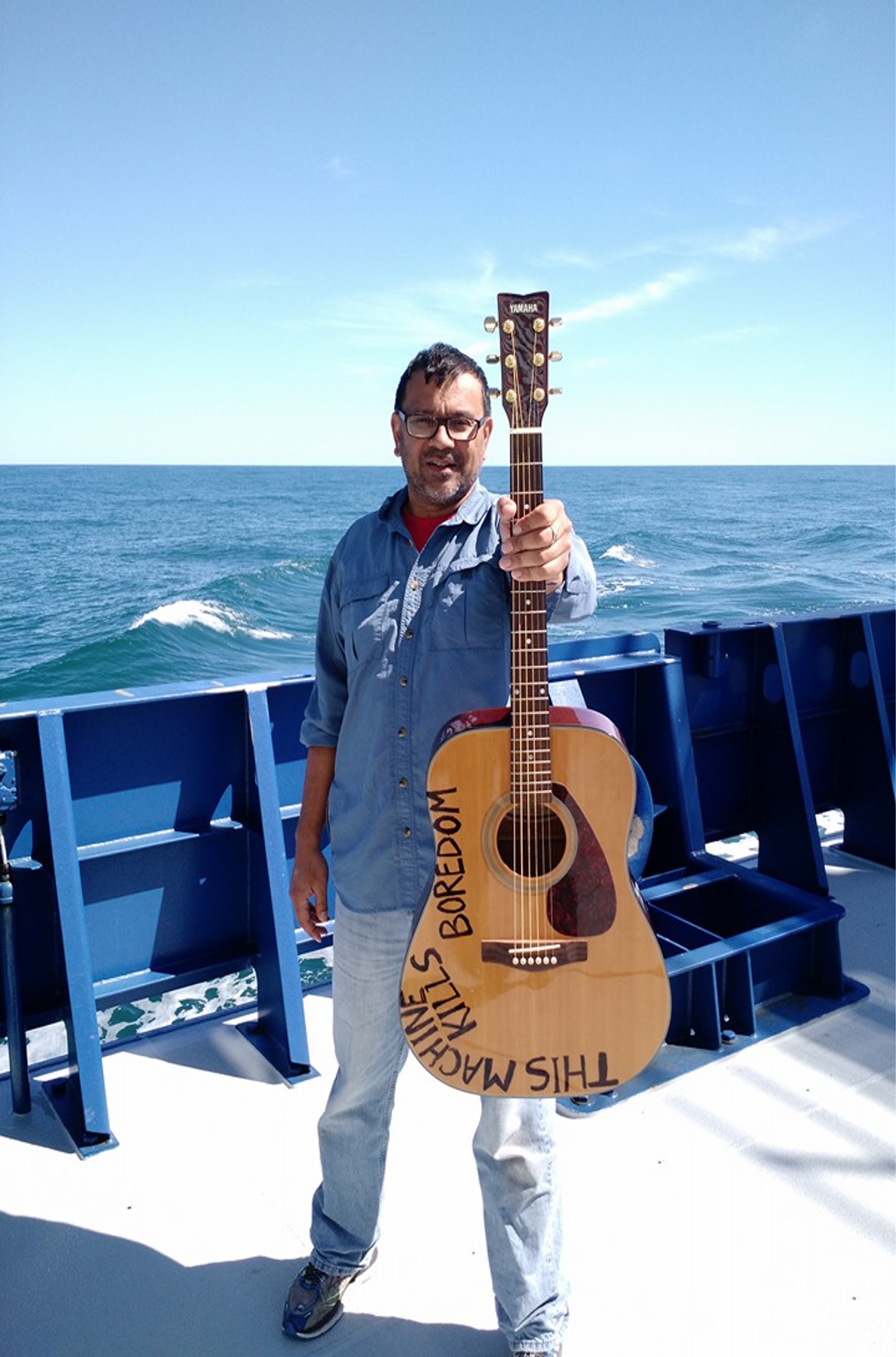 Sailing in the Gulf Stream, aboard the R/V Neil Armstrong on her  first shakedown cruise, 2015. Guitar loaned by Professor Clif Watts (East Carolina University).  Photo courtesy of Dr. Mitra.