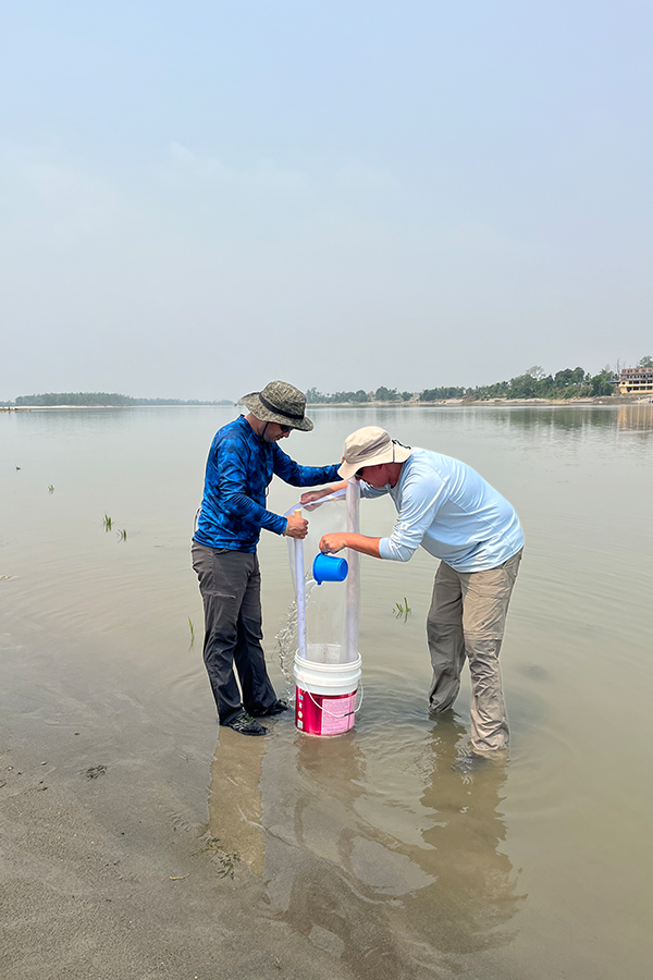 The 2023 research team samples macroinvertebrates in the Narayani River, Nepal. Photo Credit: Mary Fabrizio
